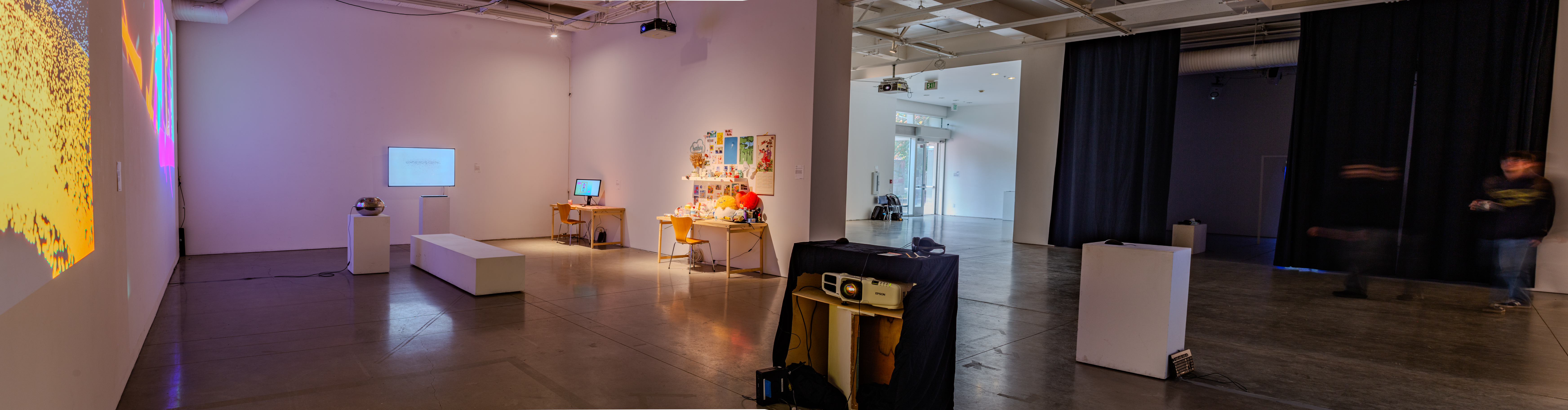 Gallery interior showing art pieces among white walls.